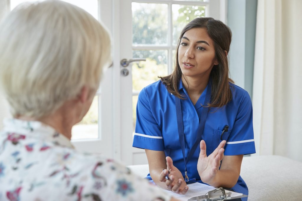 Senior talking to caregiver